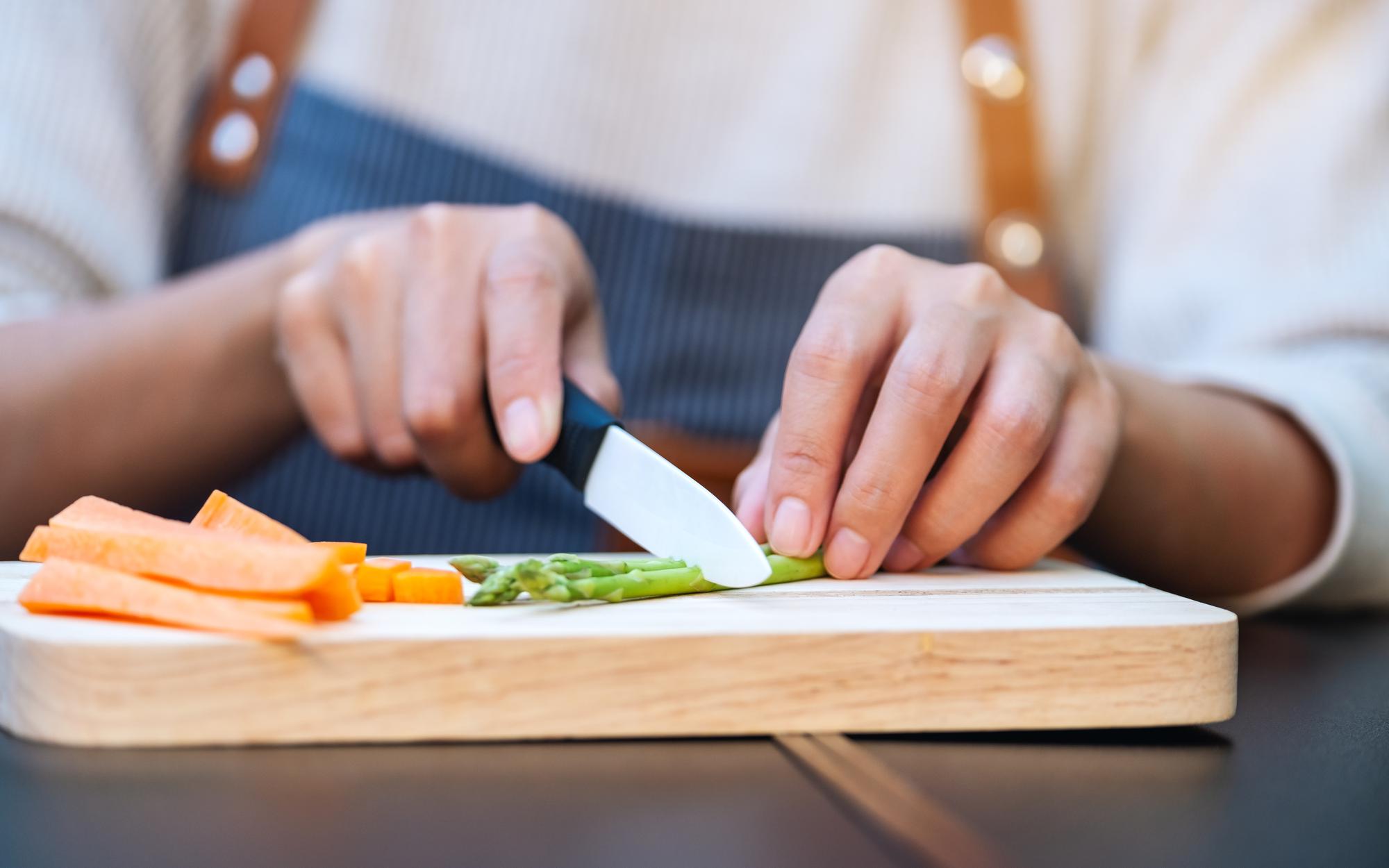 Participants practicing knife cuts on wooden boards